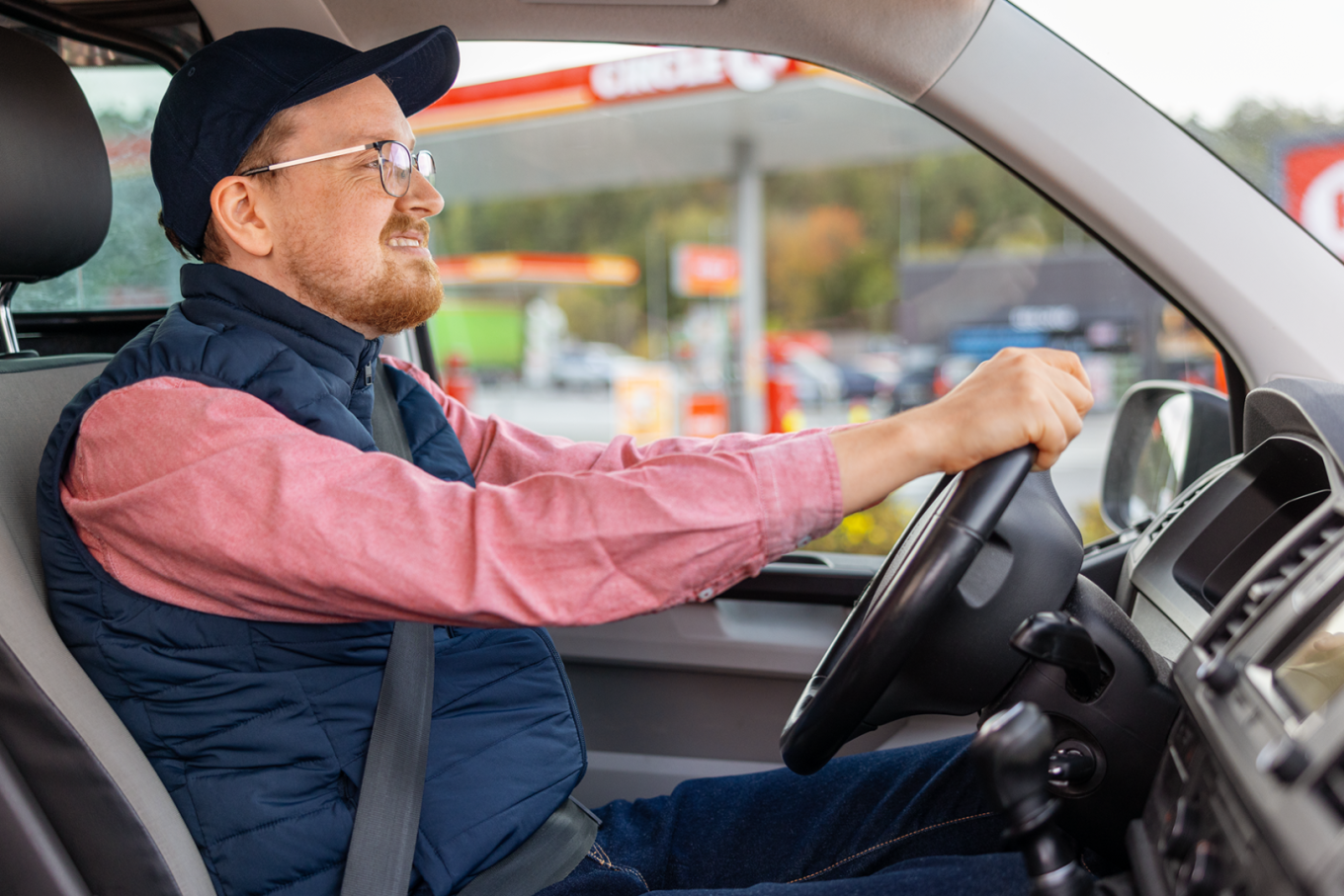 Man driving his vehicle beside a Circle K station